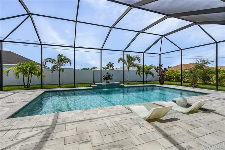 View of pool featuring a lanai, a patio area, and pool water feature