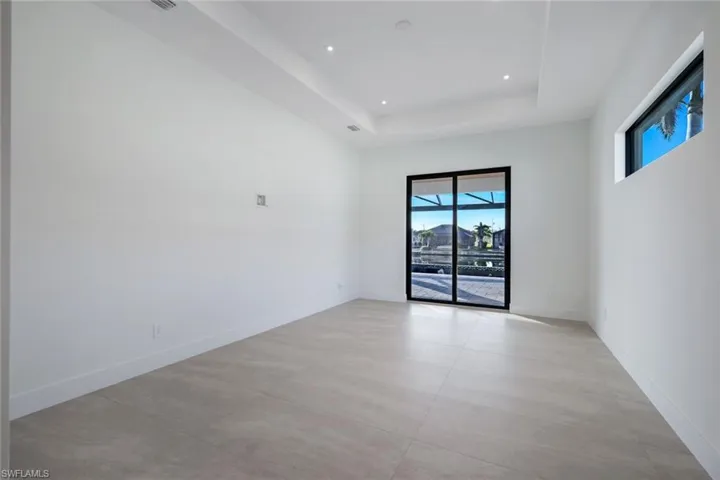 Unfurnished room with a tray ceiling