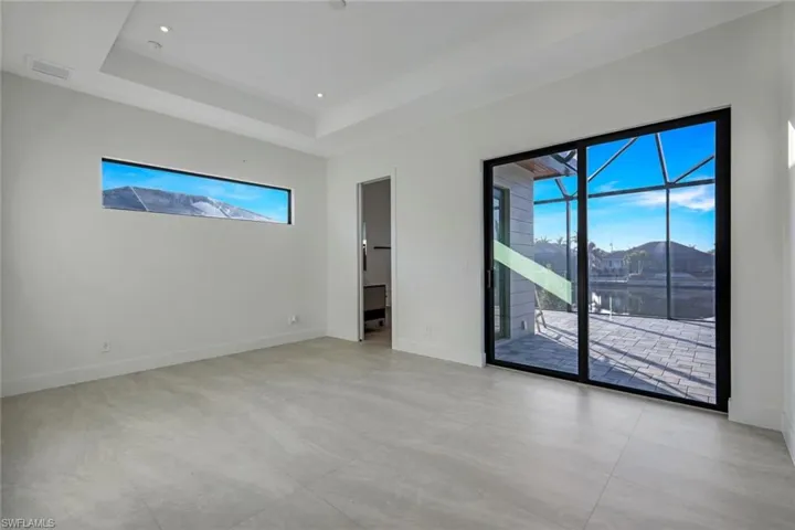 Empty room featuring a raised ceiling
