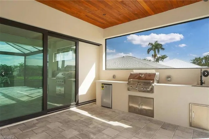 View of patio / terrace with a grill and an outdoor kitchen