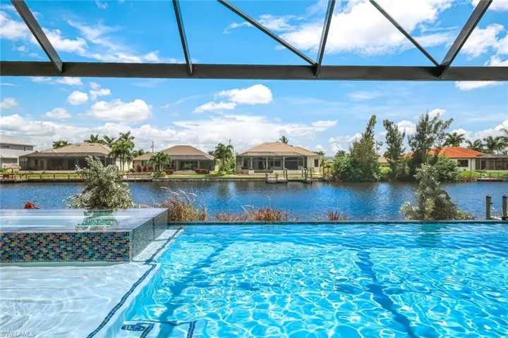 View of pool with a water view