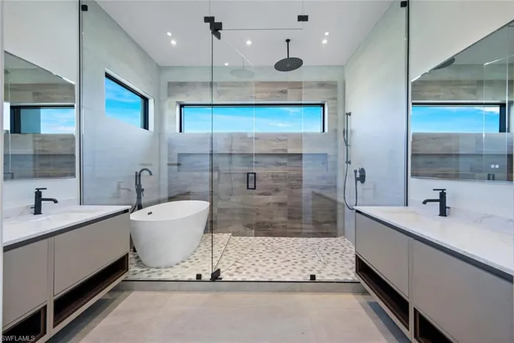 Bathroom with tile patterned floors, independent shower and bath, and vanity