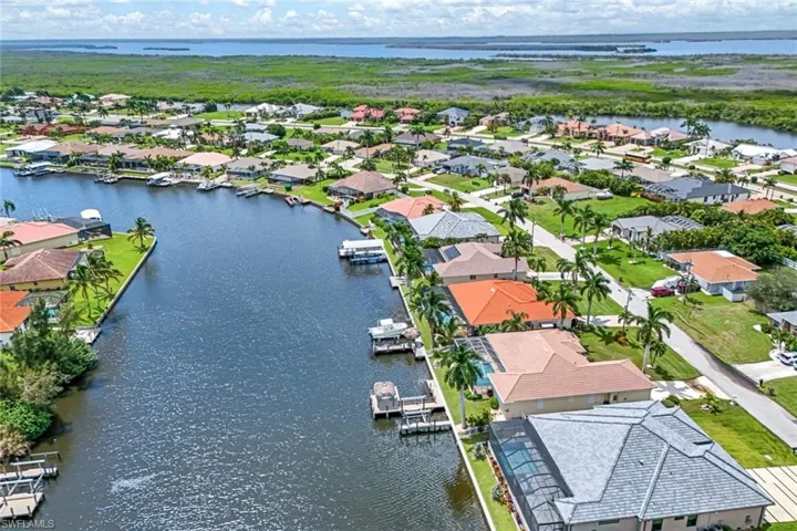 Birds eye view of property with a water view