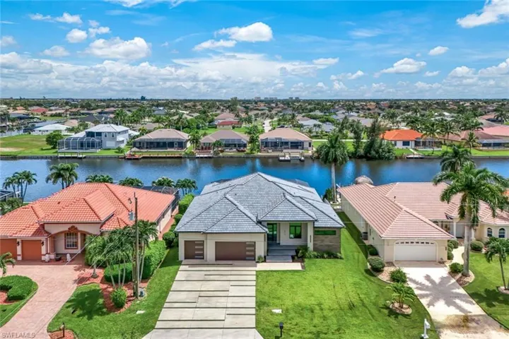Birds eye view of property with a water view