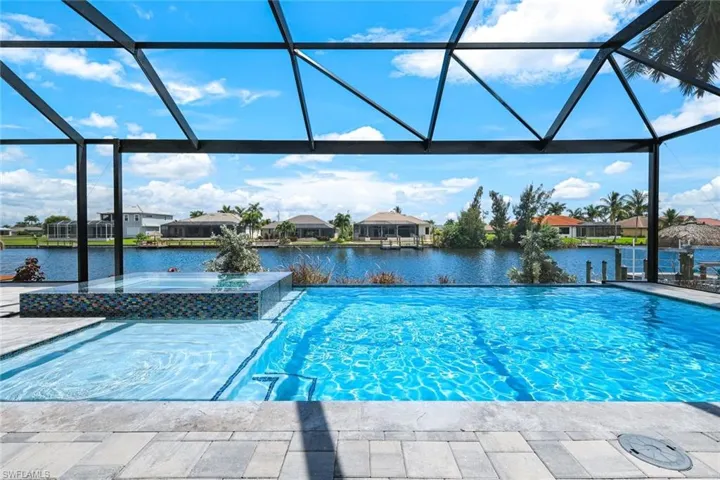 View of pool with a water view, a lanai, and a patio area