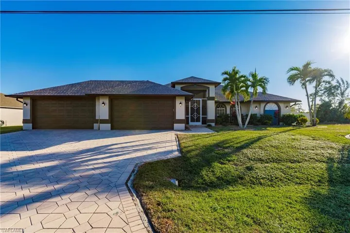 View of front of house featuring a garage and a front yard