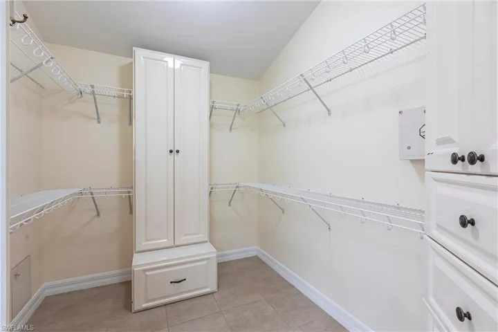 Spacious closet with light tile patterned floors