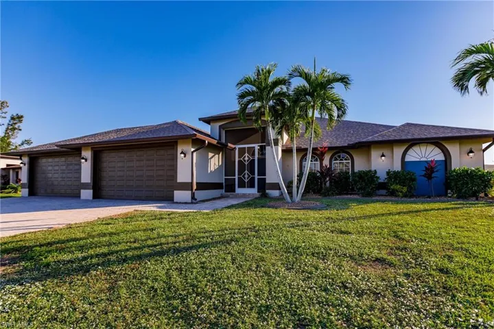 View of front of house with a front yard and a garage