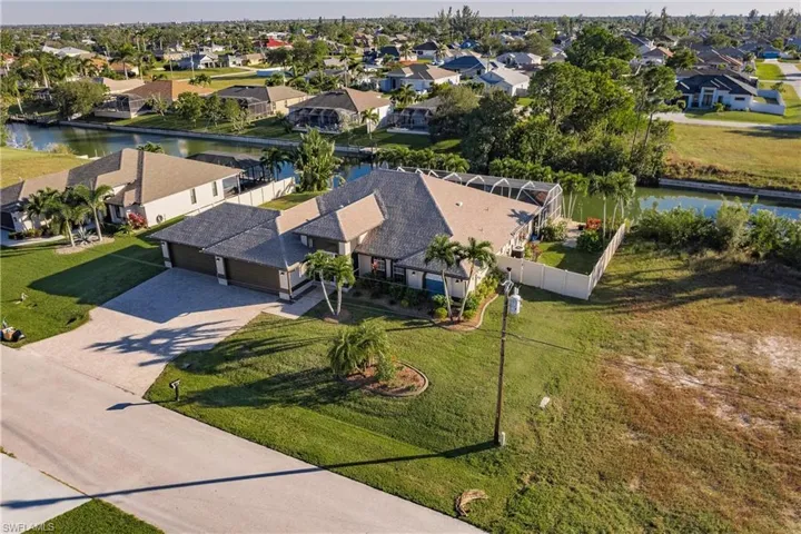 Birds eye view of property with a water view