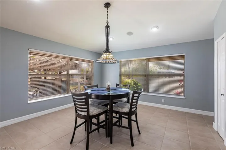 Dining room with light tile patterned flooring and baseboards