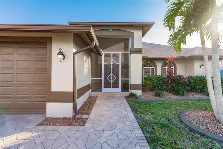 View of exterior entry with a garage