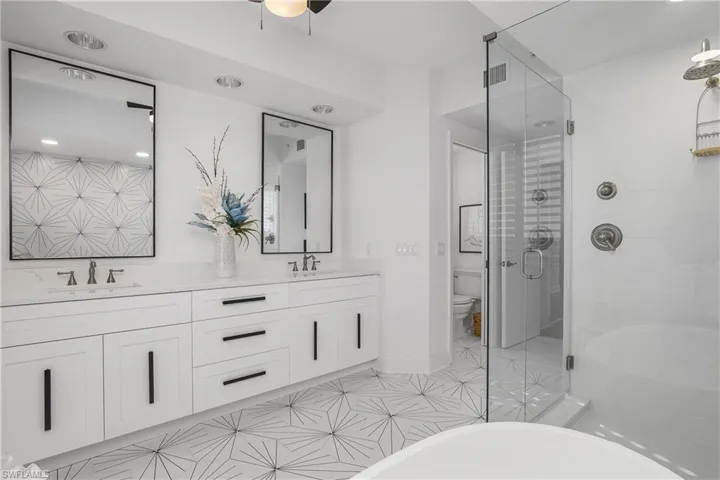 Custom cabinetry and hardware, double vanity designer Kohler sinks and faucets featuring Misterio quartz countertop