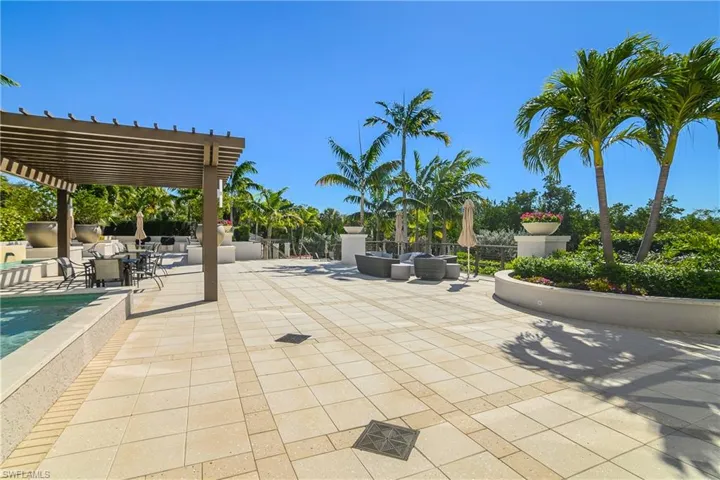 Marquesa patio / terrace featuring pergola outdoor dining space and seating overlooking Estuary
