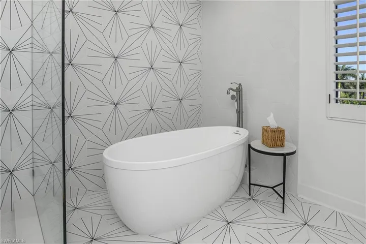 Free soaking tub with designer tile walls