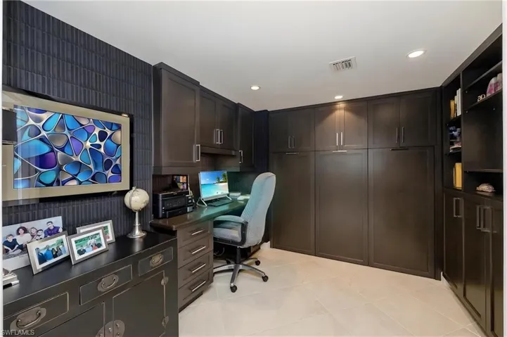 Custom built-in cabinetry and shelving define this versatile room