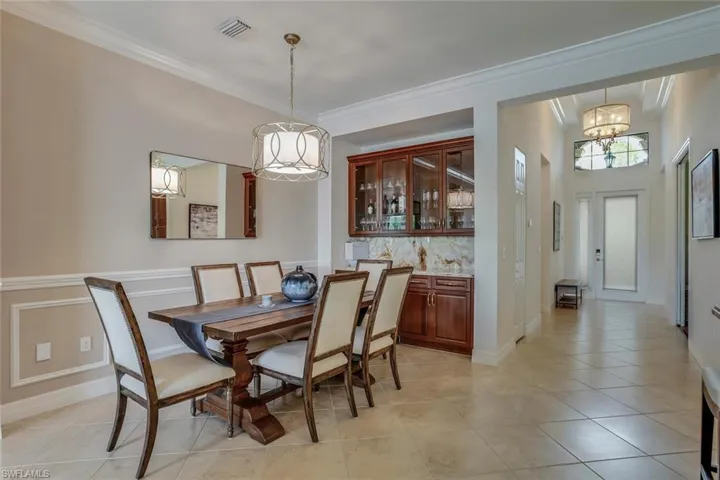 • Custom built-in bar with Viking beverage center, onyx countertop & backsplash (Plumbed andcapped, allowing for an easy upgrade to a wet bar, if desired)