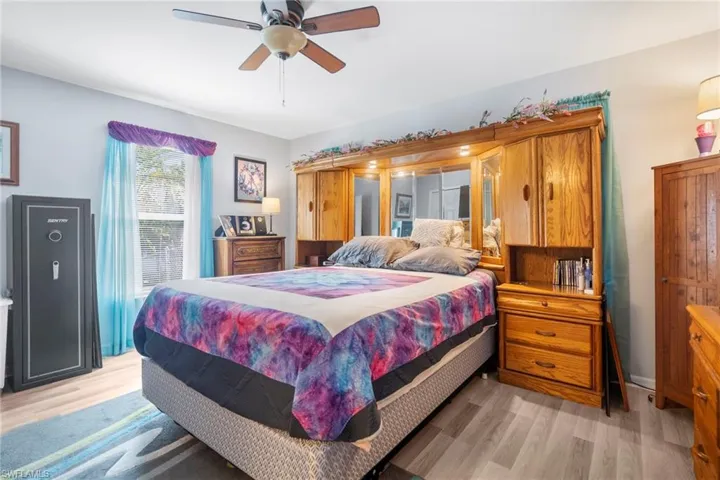 Bedroom featuring ceiling fan and light hardwood / wood-style flooring