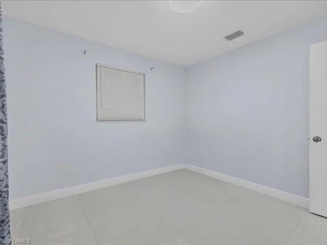 Unfurnished room with baseboards