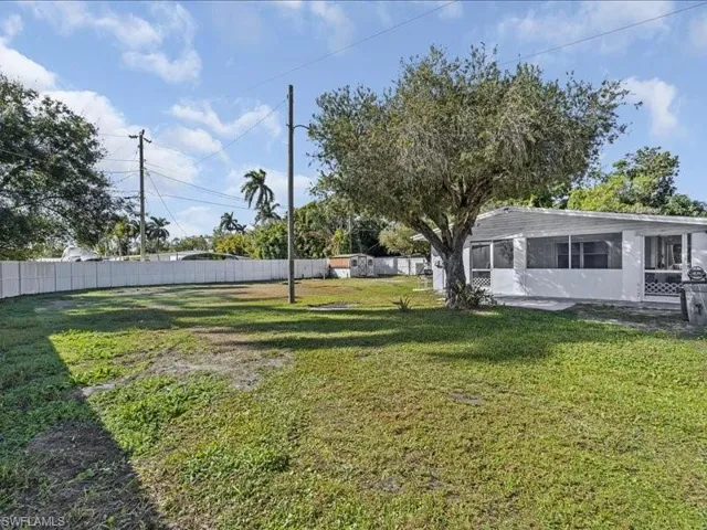 View of yard with a sunroom and a patio