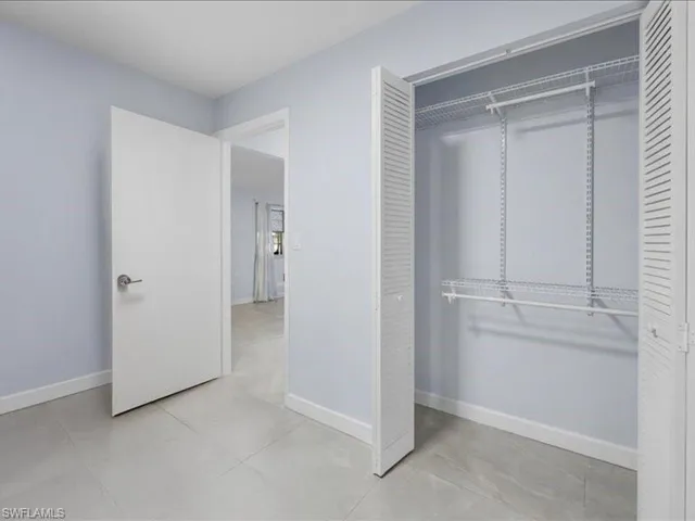 Unfurnished bedroom with baseboards and a closet