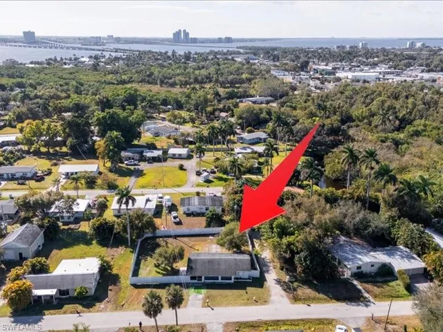 Aerial view of property's location with a large body of water and a notable bridge