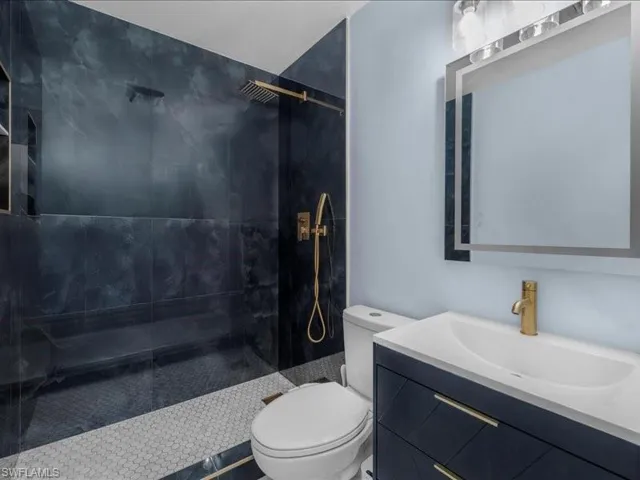 Bathroom with a tile shower and vanity