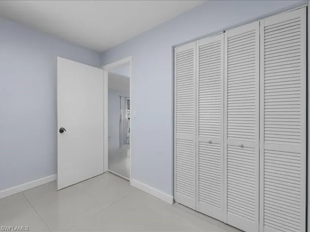 Unfurnished bedroom with a closet and baseboards