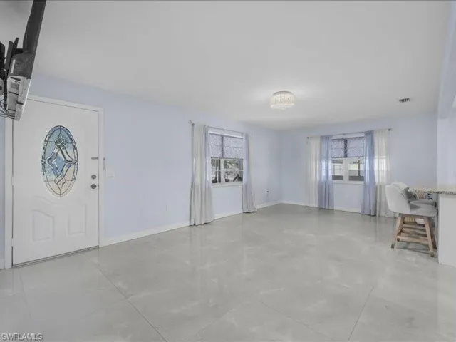 Entryway featuring living room and dinning room