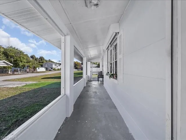 Covered porch with a lawn and a residential view