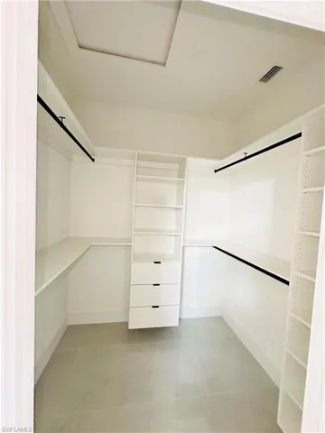 Walk in closet featuring attic access and visible vents