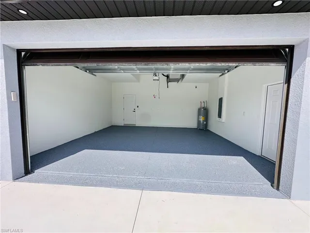 Garage with water heater and a garage door opener