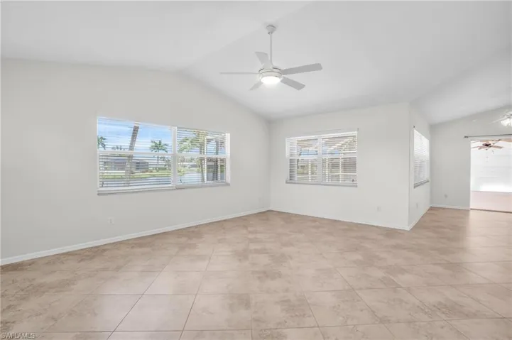 Family room featuring ceiling fan and vaulted ceiling, sliders to lanai