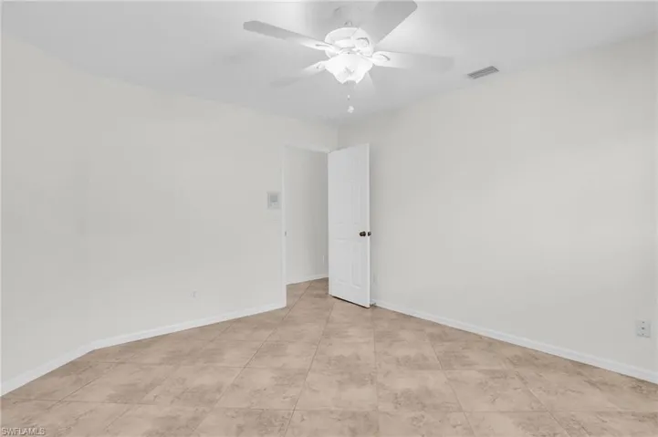 Spare room featuring light tile patterned flooring and ceiling fan