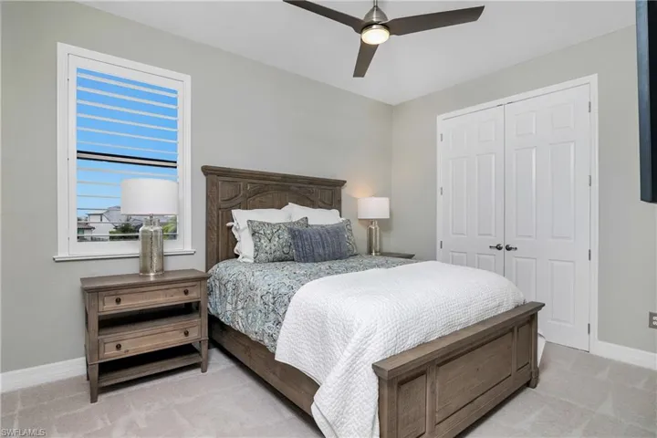 Bedroom with ceiling fan and closet
