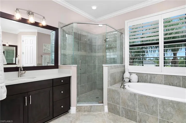 Bathroom with tile floors, shower with separate bathtub