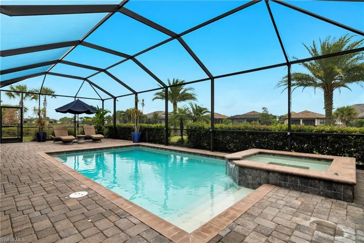 View of pool featuring an in ground hot tub, a lanai