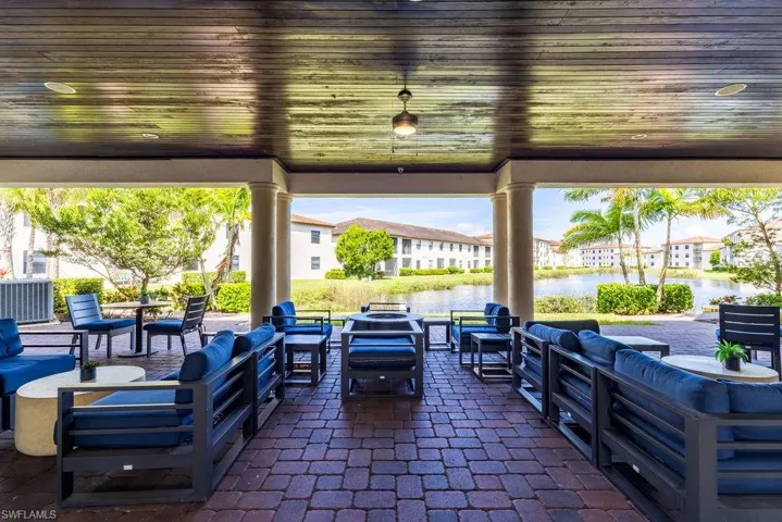 View of patio featuring an outdoor lounge area and a water view