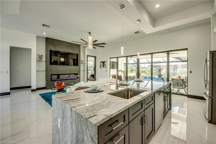 View from kitchen- featuring open living area - and 18 ft sliders allow for a quite a view when cooking