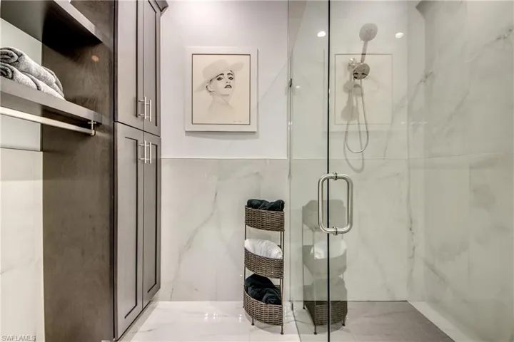 Bathroom featuring a marble finish marble finish stand up spa stile master bath