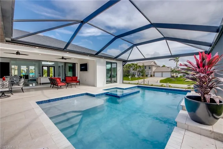 view of outdoor pool , with connected spa, and lounge pad.