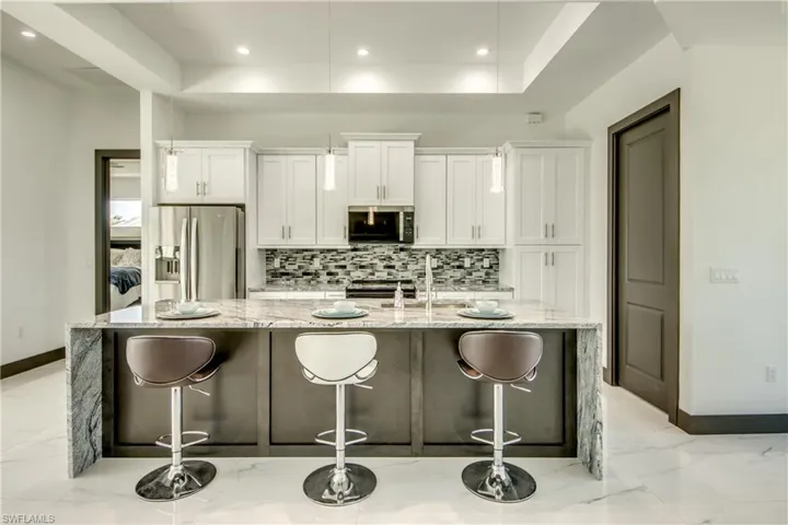 breakfast bar - featuring "waterfall" granite top- looking upon our custom soft close cabinets