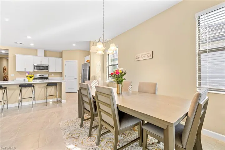 Dining space with visible vents, baseboards, a chandelier, light tile patterned flooring, and recessed lighting