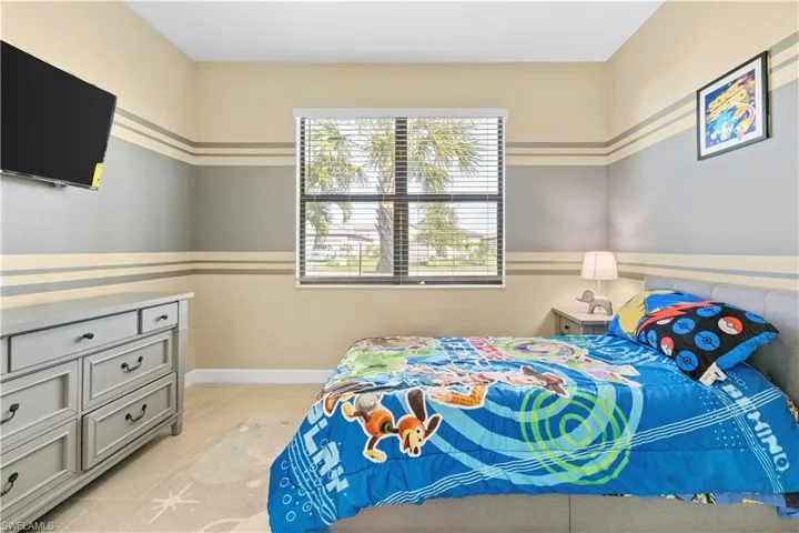 Bedroom with light tile patterned floors and baseboards