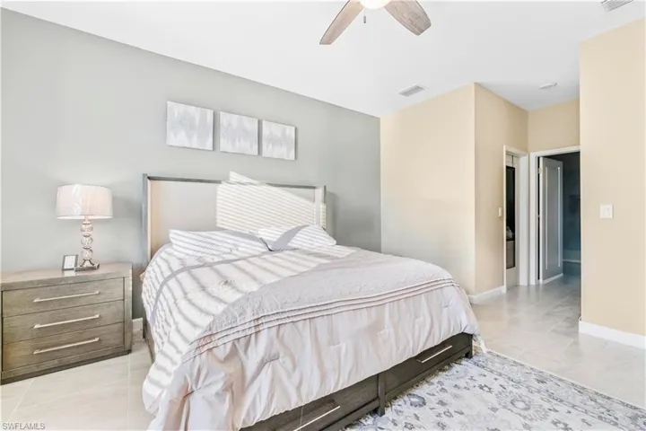 Bedroom with a ceiling fan, baseboards, visible vents, and light tile patterned flooring