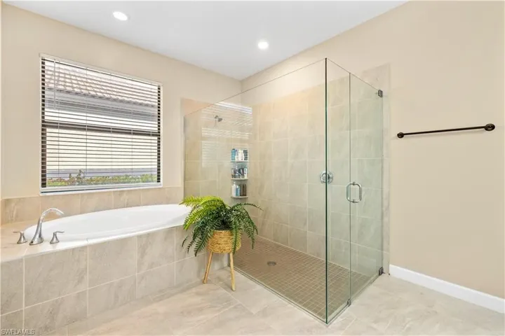 Bathroom featuring a bath, tile patterned flooring, a shower stall, and recessed lighting