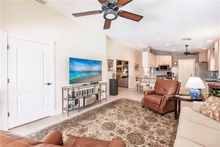 Tiled living room with sink and ceiling fan
