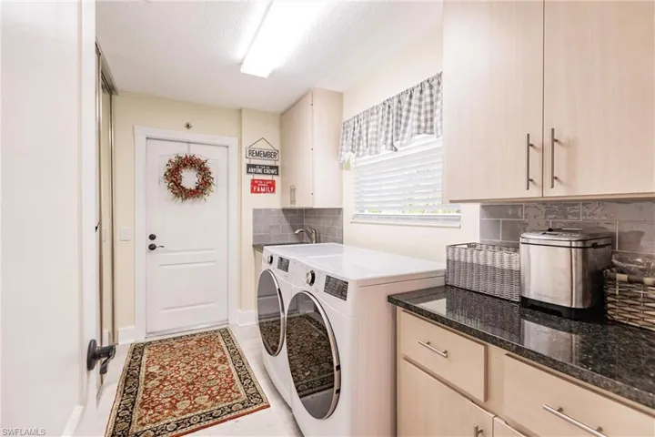 Laundry area featuring cabinets, sink, and new washer and dryer