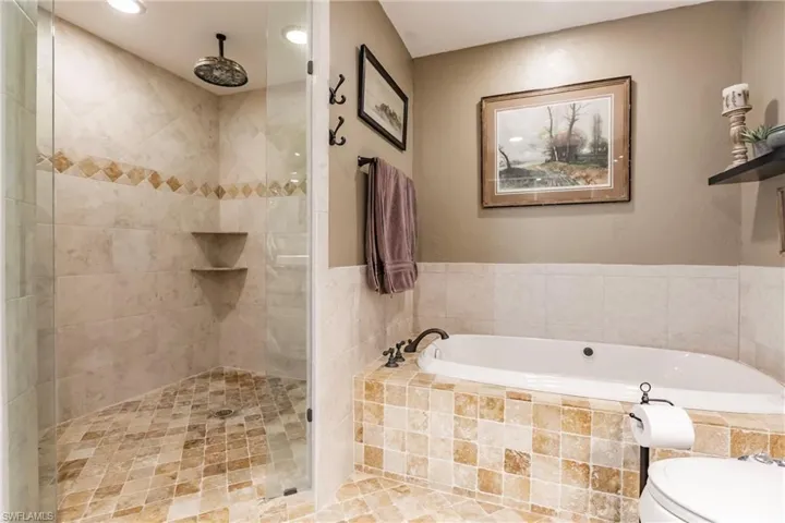The enlarged Master Bathroom featuring toilet and plus walk in shower