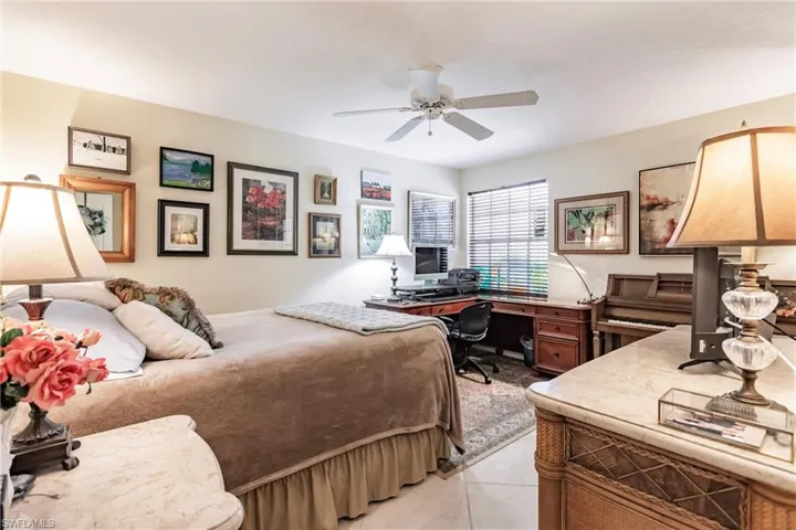 Guest bedroom with ceiling fan, and walk-in closet.