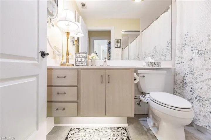 Guest Bathroom with tile floors, toilet, and vanity